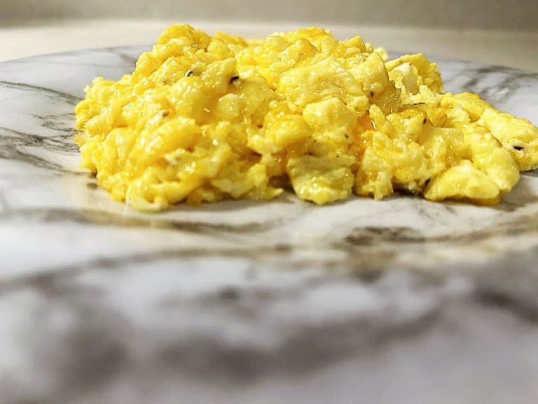 Scrambled cheese eggs on a marble plate