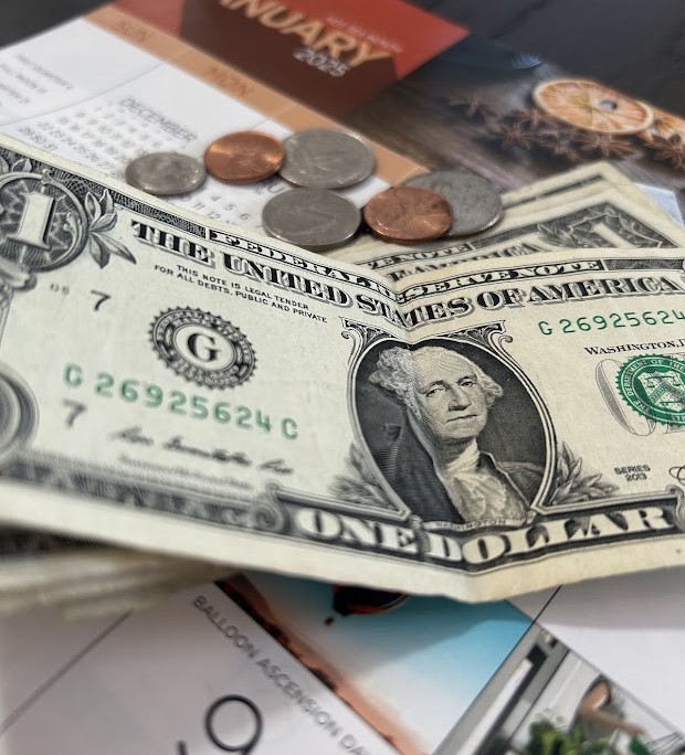 Month of January 2025 physical calendar with paper money and coins