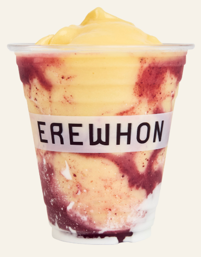 Light orange, maroon and white swirled colored smoothie in a clear plastic cup