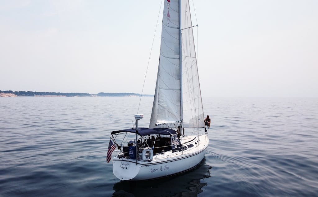 A sailboat gliding on calm Lake Michigan waters, offering a serene boating experience.